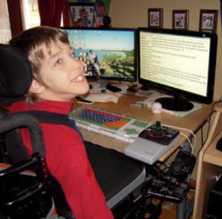 Justin smiling at computer
