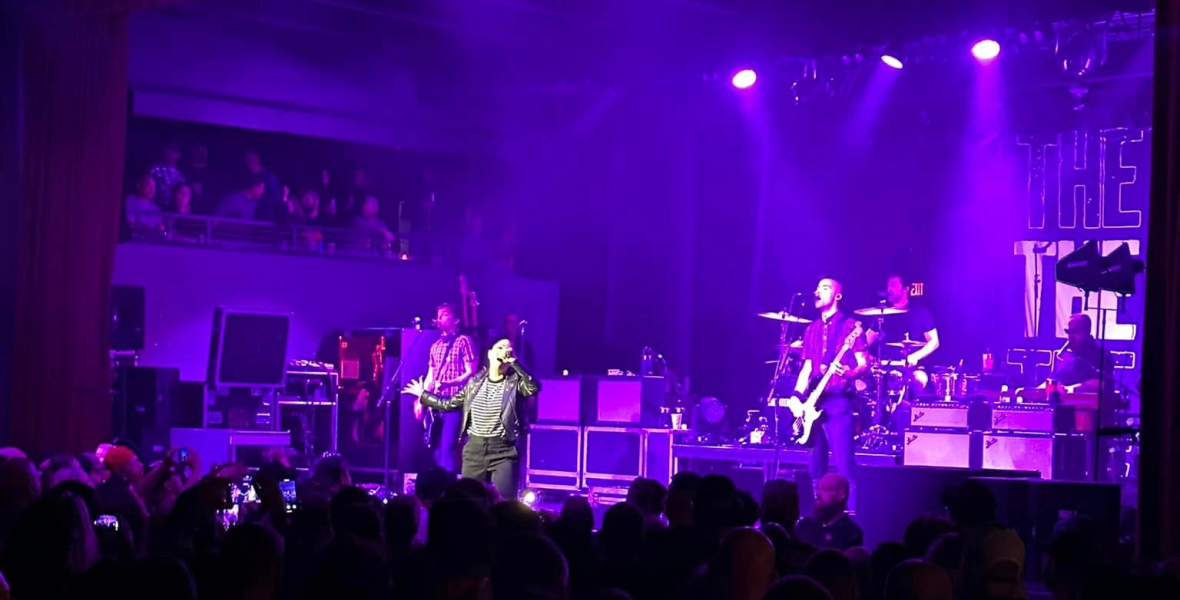 The Interrupters on stage, purple lighting, crowd